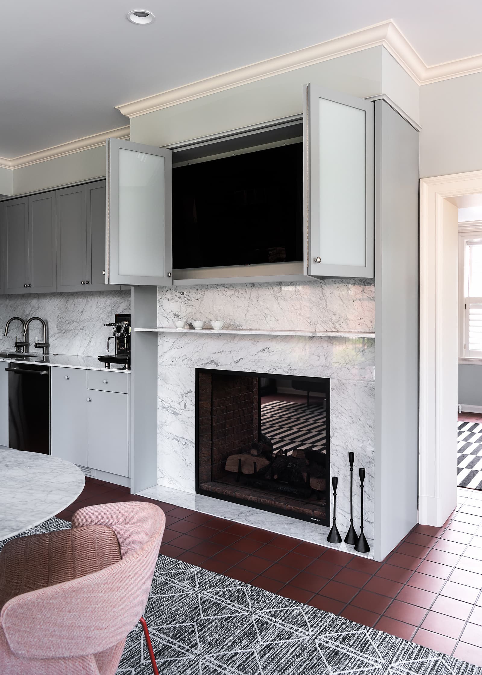 Architecture by Patterhn Ives.  Photography by Karen A Palmer.  Fireplace with television hidden behind folding cabinet doors.