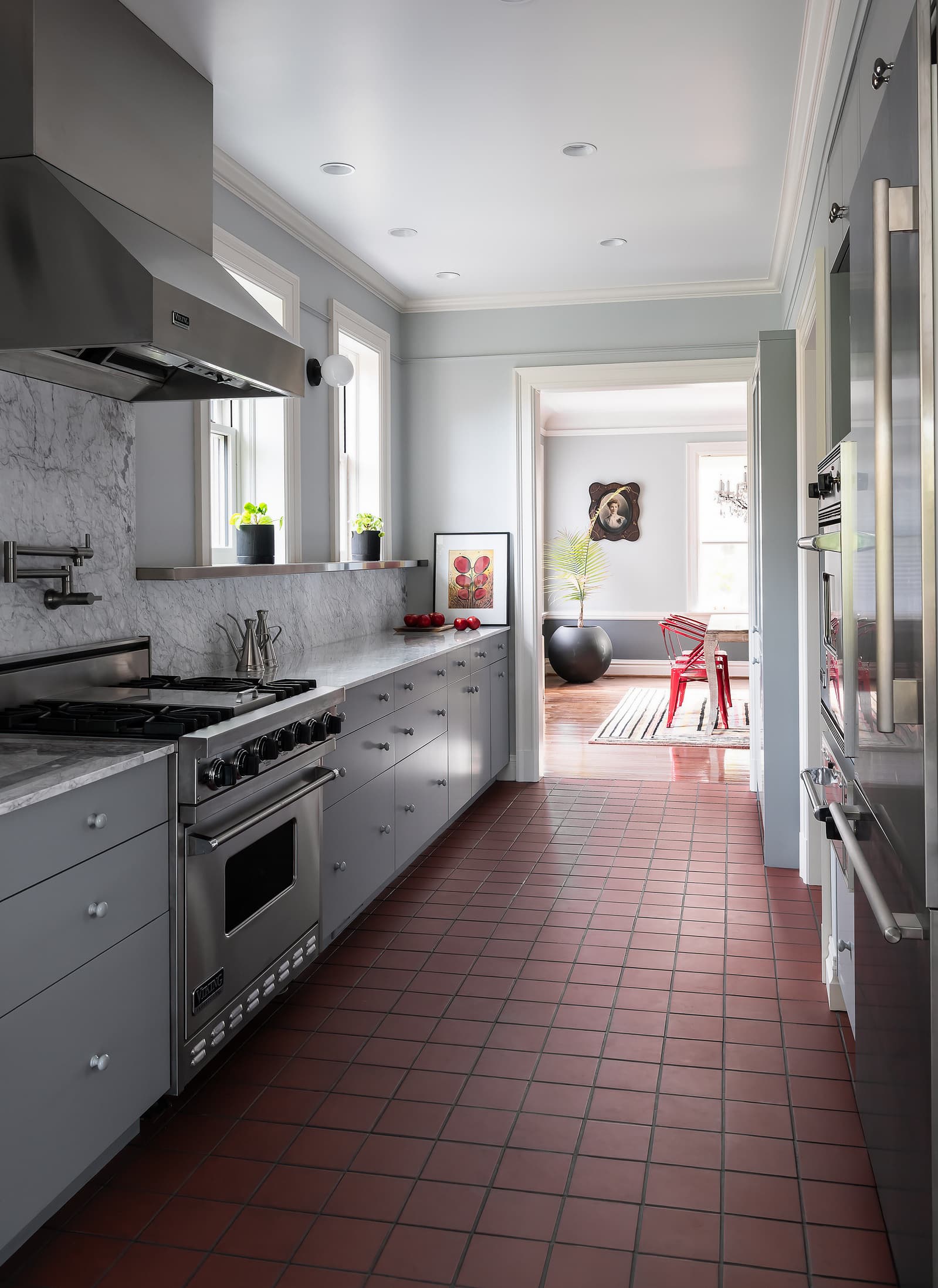 Architecture by Patterhn Ives.  Photography by Karen A Palmer.  Galley kitchen with marble surfaces. View into original dining room