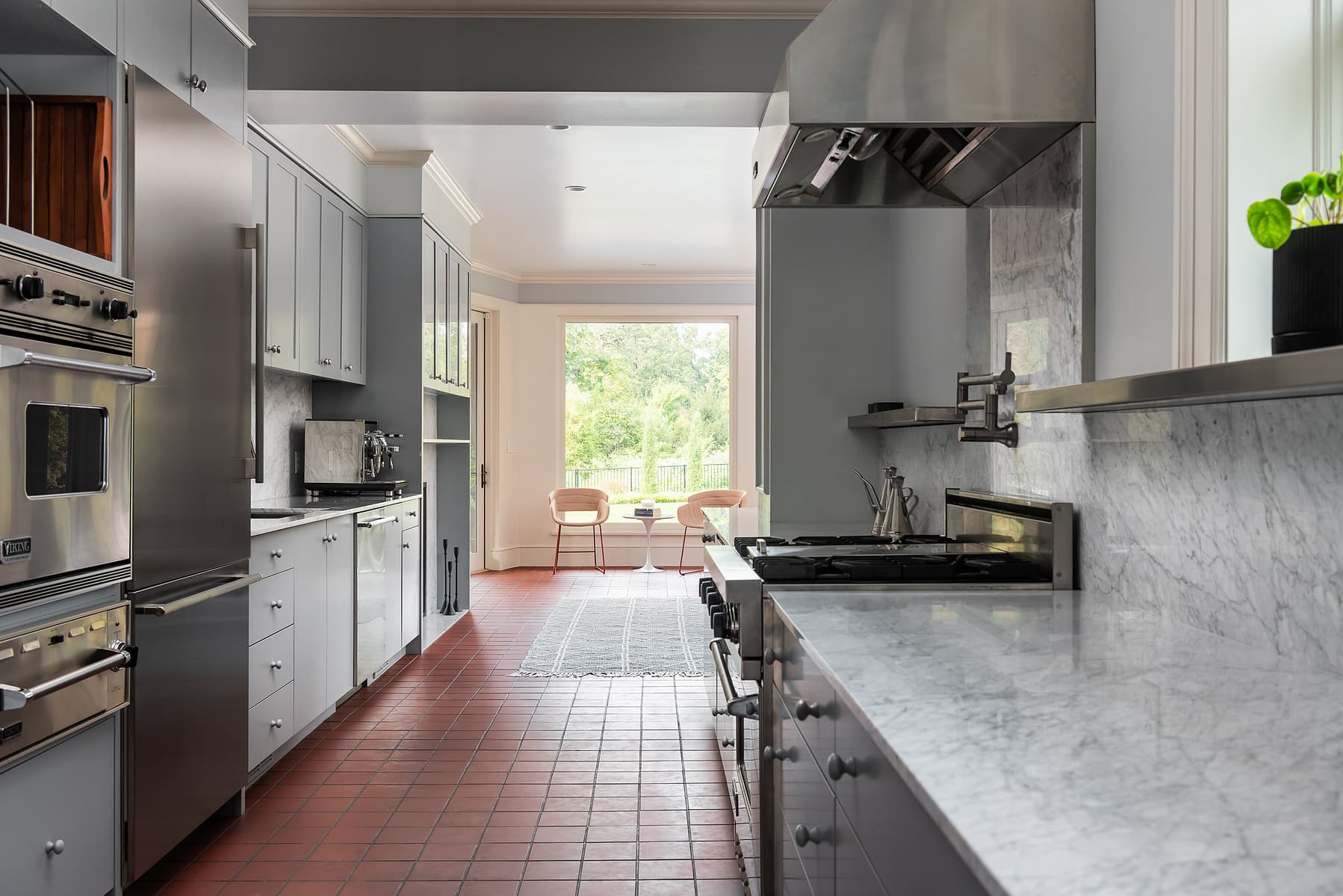 Architecture by Patterhn Ives.  Photography by Karen A Palmer.  Galley kitchen with marble surfaces. View into new addition area.