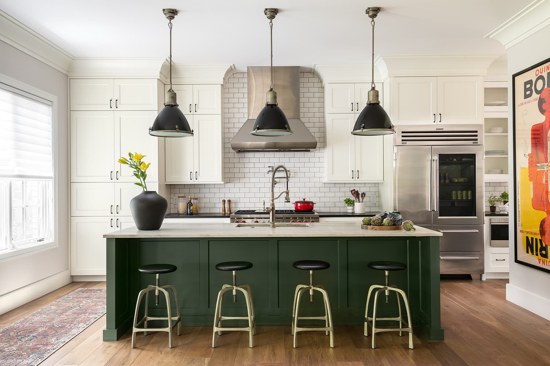 Bright kitchen with white cabinetry, green island, pendant lighting, and bar seating in a classic yet modern residential design